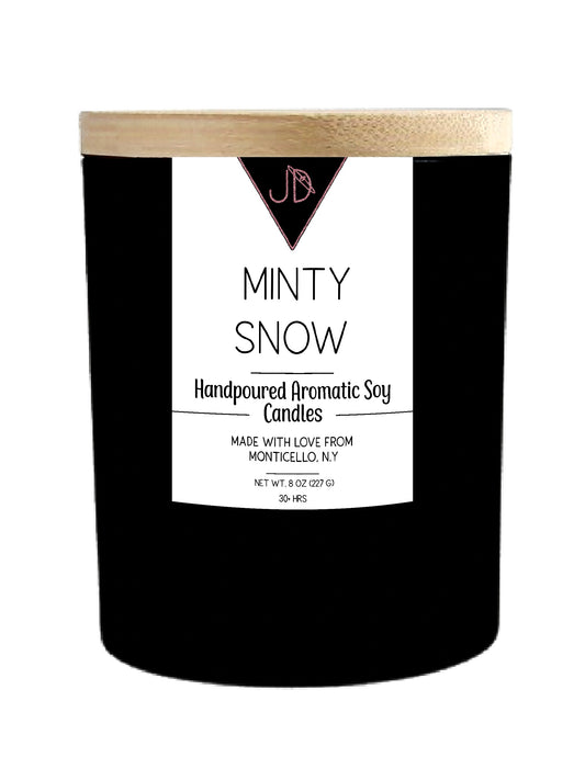 Cool, sweet, and nostalgic — like unwrapping a candy cane by the fireplace. Minty Snow opens with a crisp, cooling top note that leads into sweet peppermint, settling into a rich, creamy vanilla base.

Simple and classic, this one's a holiday staple — bright enough to feel festive, warm enough to feel like home.

Hand-poured in small batches in Monticello, NY using clean-burning soy wax and a cotton wick, Minty Snow burns true to scent for 30+ hours. Finished with a natural wood lid for a clean, minimal loo
